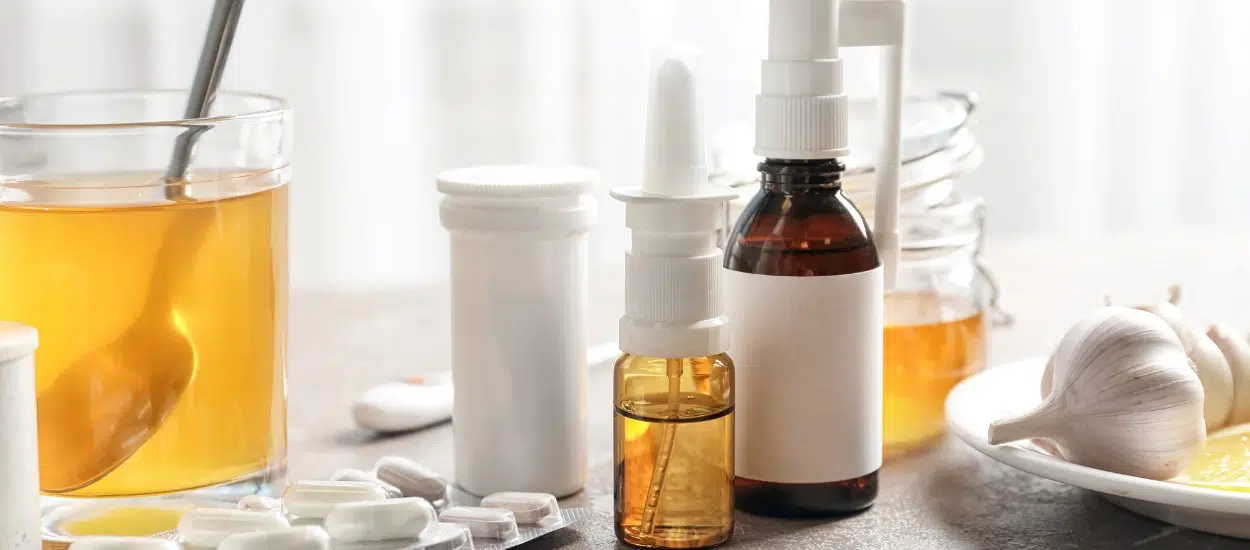 A bundle of medicated remedies (throat spray, nasal spray and tablets) and home remedies (lemon, citrus tea and honey).